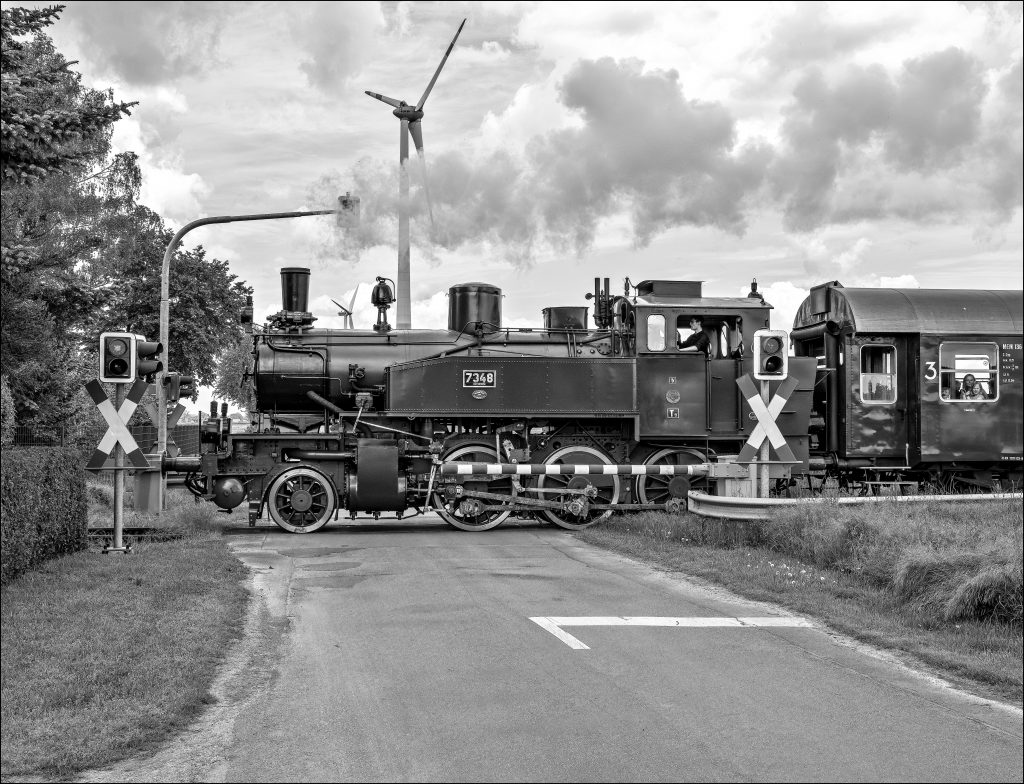 Steam egine, railway crossing, wind turbine