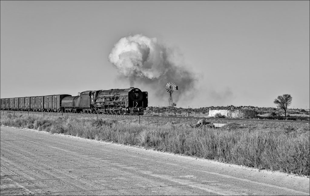 Steam Engine, Class 25NC, Freight Waggon, Track, Gravel Road, Windmill, Water Tank, Tree.