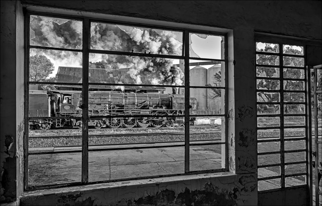 Steam Engine, Class 25NC, Goods Shed, Tracks, Wheat Silo, View through window.